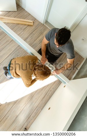 Couple assembling furniture in their new house