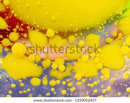 Drops of yellow paint, an abstract background. Close up macro shot. Blurred background. Selective soft focus. Abstract universe of paint spheres and spots. Colourful abstract pattern