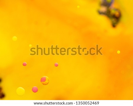 Glittering bubbles on abstract background. Close up macro shot. Blurred background. Selective soft focus. Yellow and pink spheres in abstract orange universe. Bubbles in space