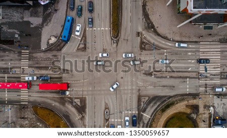 Aerial shot of the intersection street in Tartu with cars waiting in line for the traffic light and seen the intersection road so clean
