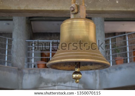 Picture of a ancient epic copper bell hanging in the temple