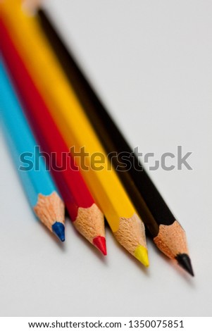 four pencils in the CMYK colours