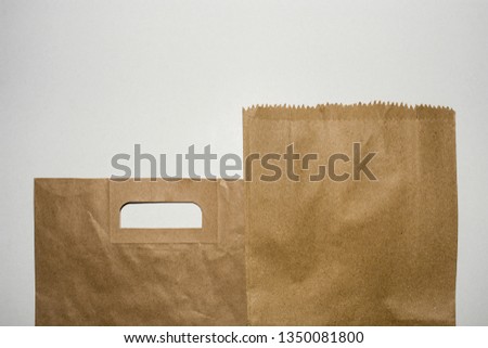 Brown paper grocery bags on white background. Plastic free, environment friendly concept. Reuse bags, reduce waste and save our earth.