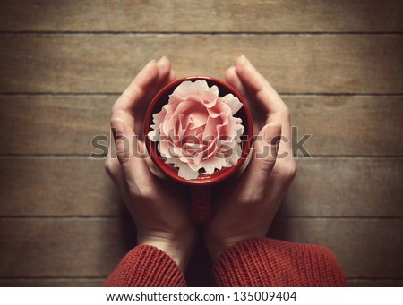 woman holding hot cup of tea