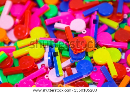 Blurred photo of Colorful Plastic Whistle – Great for Children and Features a bold, crisp sound