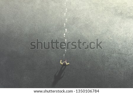 man following mysterious footsteps on the street Royalty-Free Stock Photo #1350106784