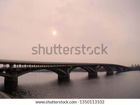 Sunset over the bridge in the city in the evening
