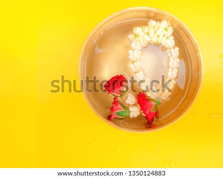 web banner design for spring and summer season festival concept from minimal flat lay tropical flower with orchid ,rose decorate on pastel yellow background for songkran ceremony 
