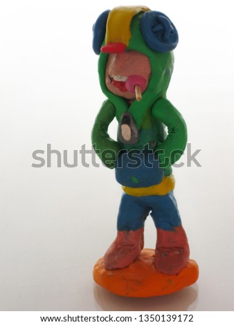  Plasticine boy with candy in his mouth.                              