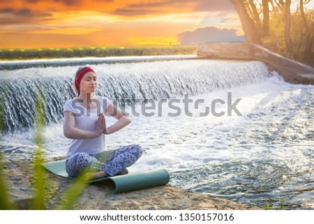 Female Practising Yoga and meditation near Waterfall. Stock image. - Image
