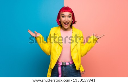 Young woman with yellow jacket with surprise and shocked facial expression