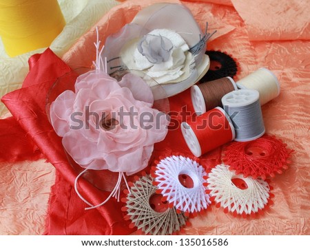 Closeup picture of threads and decorative handmade flowers