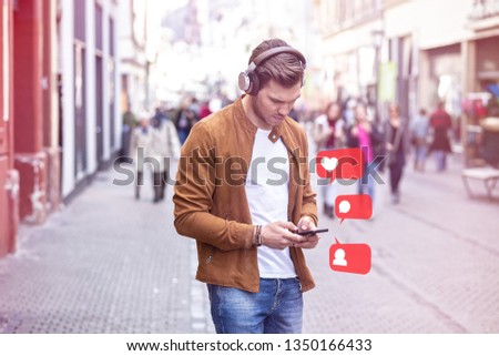 Young Adult Man Using Social Media on Smartphone on The Street at Summer Time - Like, Follower, Comment Icons in Speech Bubble
