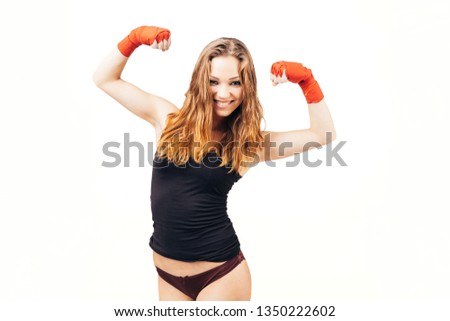 Pose of a beautiful woman with hands wrapped in protection bandage and wearing panties smiling to the camera after a victory – isolated on white.
