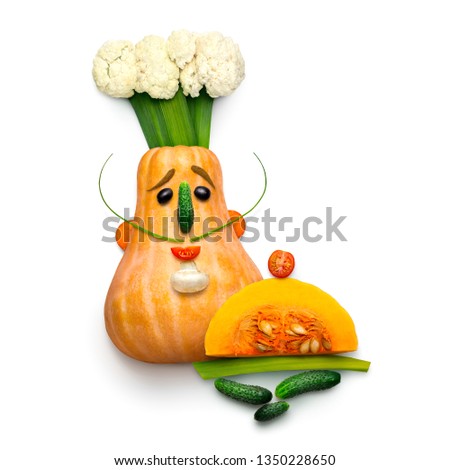 Creative diet food healthy eating concept photo of a funny cartoon chef made of pumpkin fresh fruits and vegetables full of vitamins on white background.