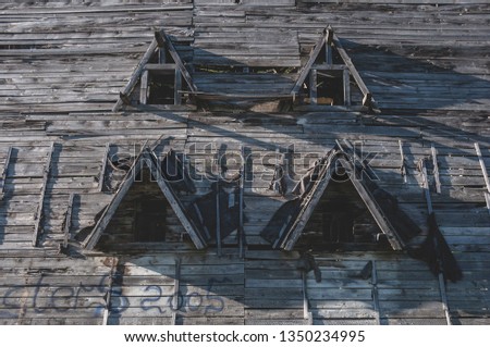 Old building roof with broken wooden tiles