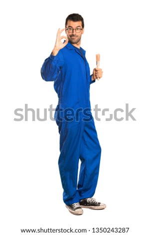 A full-length shot of a Painter man showing an ok sign with fingers on isolated white background