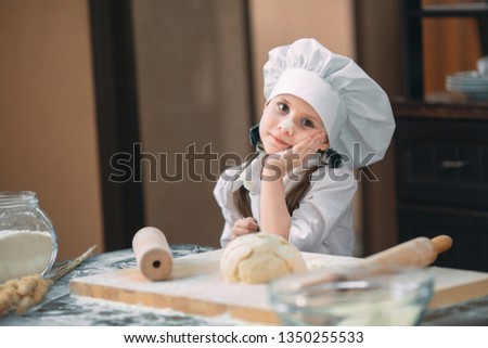 girl kid are preparing the dough in the kitchen