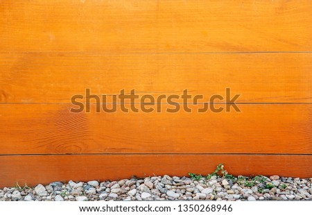 Horizontal wooden Board brown with bitches on the surface and small stones at the bottom .Texture.Background.