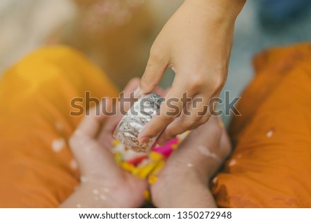 People pouring water to Buddhist Monk and gives blessing in Thailand Songkran annual festival in Buddhist temple.