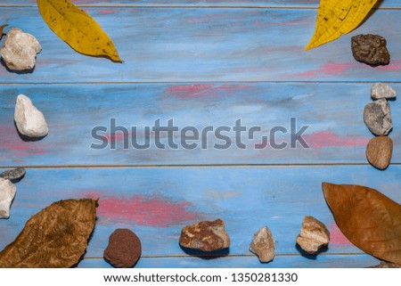 blue toned wooden background with summer objects in the corners with space to edit text