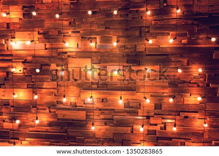 Modern dark classical style interior design apartment with retro lamps hanging light bulbs background. Wooden planks with lamps. Decorated interior room with gold lights. Copy space mockup poster