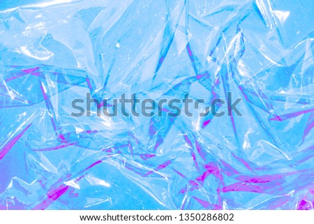 Blue and violet crumpled polythene abstract background.