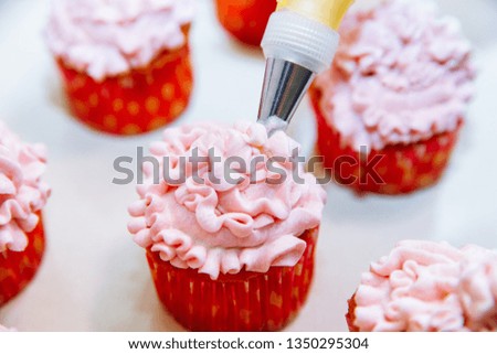 Cooking cupcakes at home. Pink Cream Baking Decoration