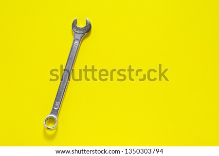 Spanner key on yellow  background. Screw driver set.  Background for your text and design.