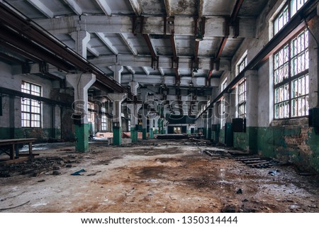Abandoned industrial building interior Royalty-Free Stock Photo #1350314444