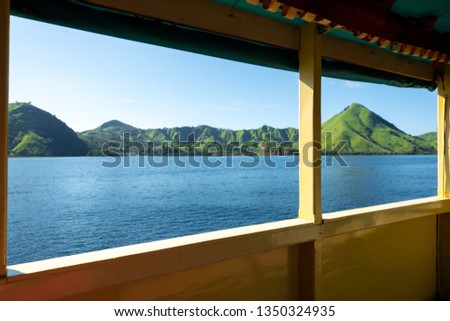The view kelor island take from window boat. Beautiful panorama view of the island with Kelor island. Looking Out from the Top of Kelor Island, near Komodo National Park, Flores, Indonesia. 