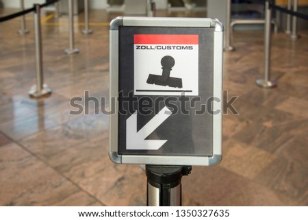 Bilingual customs  control sign at international airport