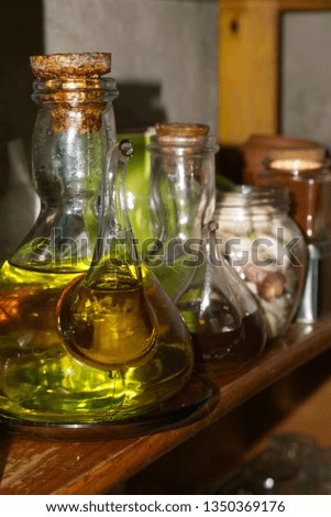                         jars of oil and vinegar in bookshelf       