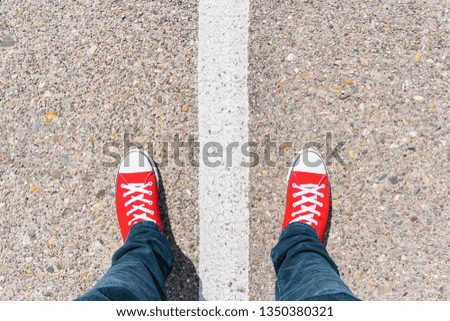 Man standing on grunge asphalt city street with white line on the floor, point of view perspective Royalty-Free Stock Photo #1350380321