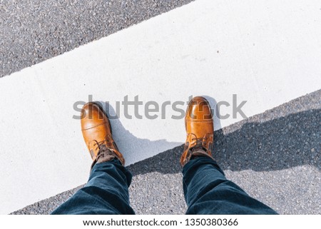 Man standing on grunge asphalt city street with white line and copy space, point of view perspective Royalty-Free Stock Photo #1350380366