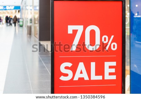 Large Sale 70 off letters on shopping mall wall pillar, bokeh shopping mall as background.Final sale.shopping, business fashion and advertisement concept.70 off sale banner at the clothing store