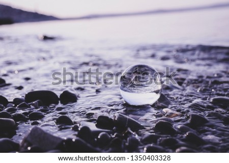 If you put a Lens ball in water, it creates a beautiful effect of reflection. Picture taken on Barcola Beach, Trieste, at sunrise. 