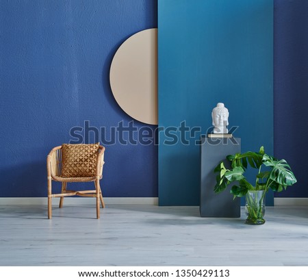 Modern dark blue stone wall, textured wall, blue decorative wall, chair vase of plant and table interior concept. Home wall background. parquet and modern background.