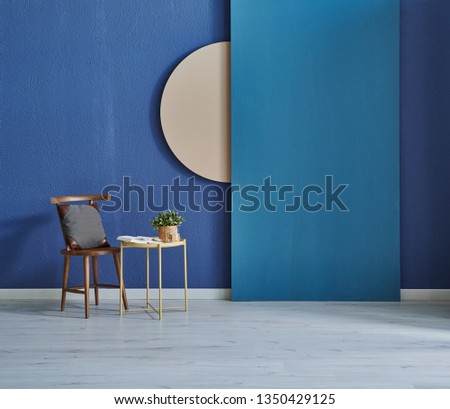 Modern dark blue stone wall, textured wall, blue decorative wall, chair vase of plant and table interior concept. Home wall background. parquet and modern background.