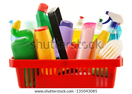 Shopping basket with detergent bottles and chemical cleaning supplies isolated on white Royalty-Free Stock Photo #135043085