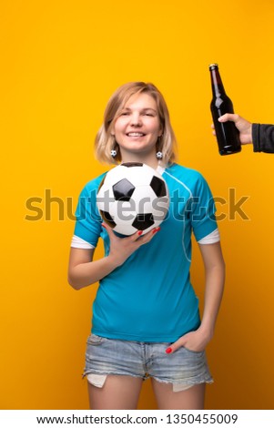 Photo of sports blonde with arms crossed is choosing between ball and bottle of alcohol