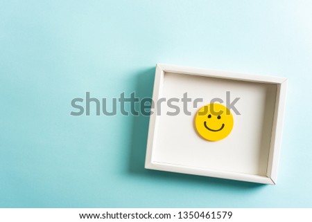 Concept of well done sign emoji, feedback, employee recognition award. happy yellow smiling cartoon face frame on blue background.