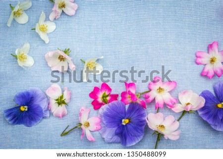 Subtle, floral frame on blue fabric