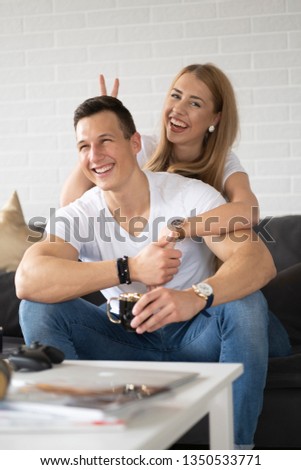 Young couple spending time together at home drinking coffee and talking.