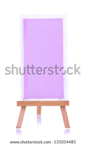 Small easel with sheet of paper isolated on white