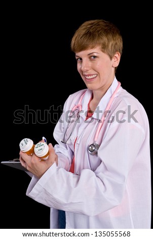 Female doctor filling out paperwork on a clipboard. Shot on a black background.