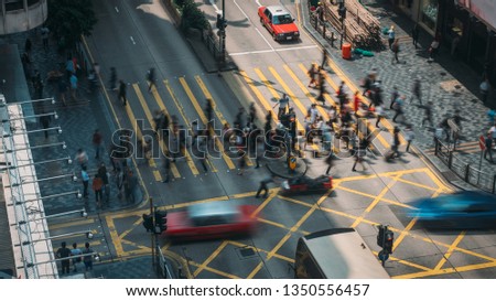 People and taxi cabs crossing a very busy crossroads in Tsim Sha Tsui district Hong Kong, China Royalty-Free Stock Photo #1350556457