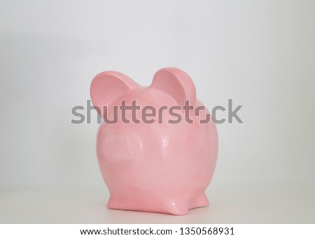 Pink piggy bank on a white studio background, The concept of saving for the future in retirement