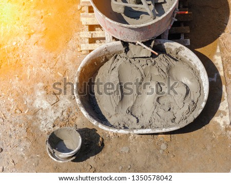 Top view Cement or mortar is inside cement mixer pouring in basin in construction site