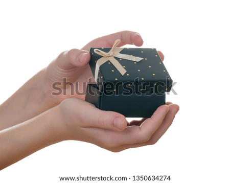 Child opens hands black box with Golden ribbon isolated on white background.